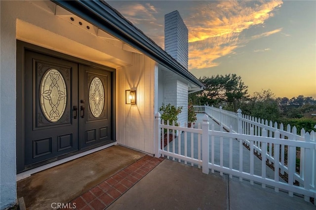 29461 Via Valverde, Laguna Niguel, CA 92677 - exterior entry at dusk featuring a chimney and fence