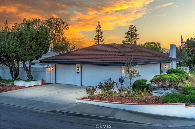 29461 Via Valverde, Laguna Niguel, CA 92677 - view of front of house featuring a tile roof, concrete driveway, a chimney, fence, and a garage