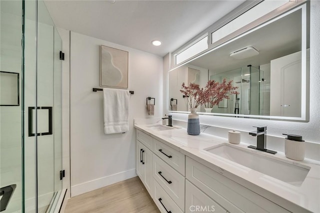 29461 Via Valverde, Laguna Niguel, CA 92677 - bathroom featuring baseboards, wood finished floors, a sink, and a stall shower