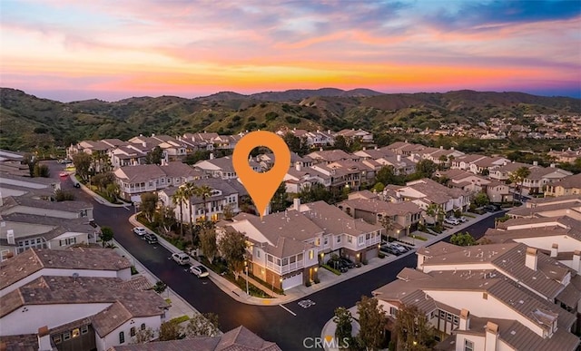 aerial view at dusk with a residential view and a mountain view