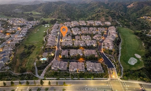 birds eye view of property featuring a residential view, a mountain view, and golf course view