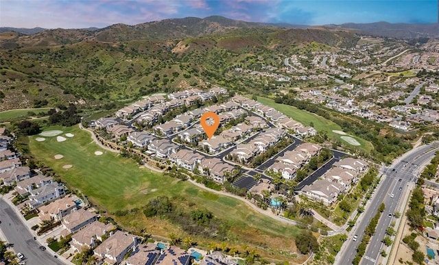 birds eye view of property featuring view of golf course, a residential view, and a mountain view