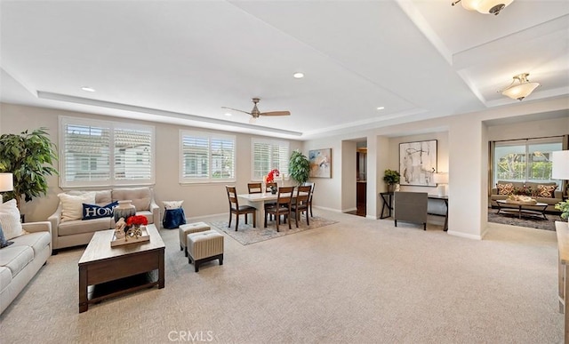 carpeted living room with baseboards, recessed lighting, a raised ceiling, and ceiling fan