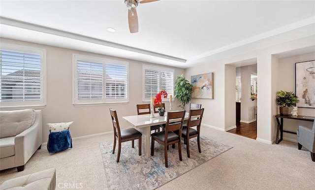 carpeted dining area with baseboards