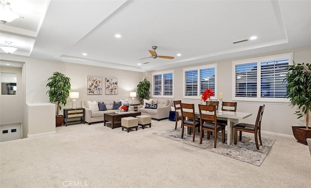 carpeted dining room featuring recessed lighting, visible vents, and a raised ceiling