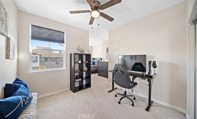 office space featuring baseboards, light colored carpet, and ceiling fan