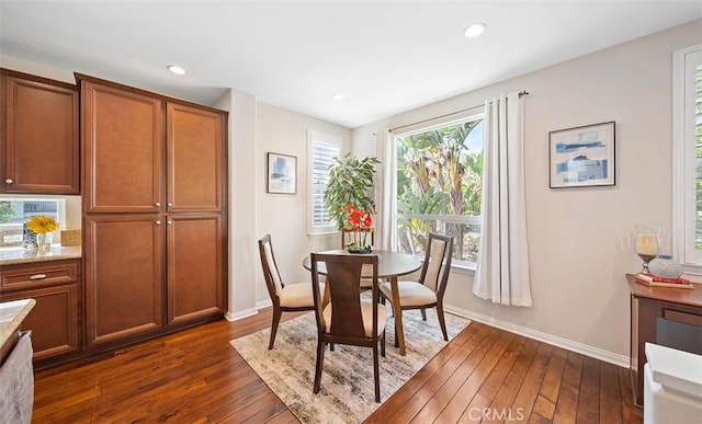 dining area featuring recessed lighting, baseboards, and dark wood-style floors
