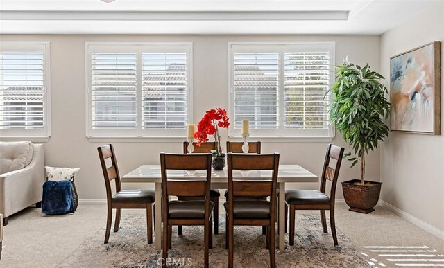 dining area with baseboards, carpet, and a wealth of natural light