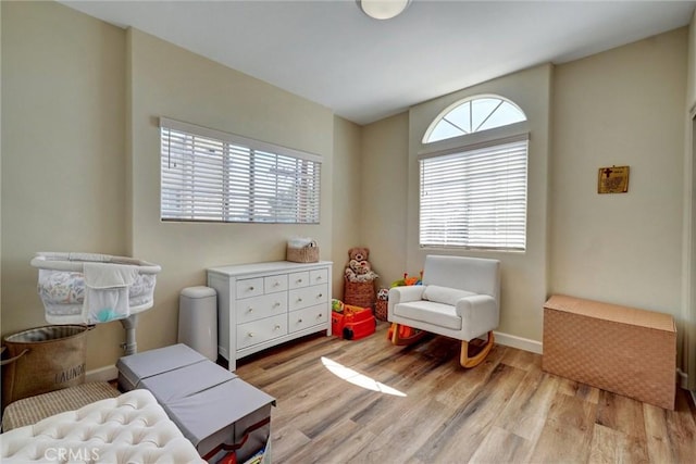 bedroom featuring baseboards and light wood-style floors