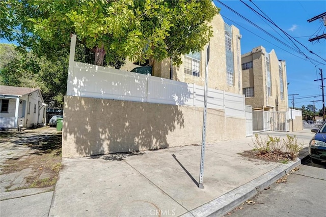 view of property exterior featuring fence and stucco siding