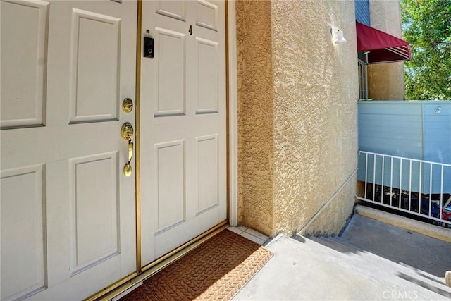 doorway to property with stucco siding