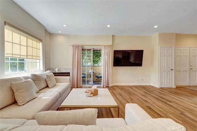 living area featuring baseboards, recessed lighting, and wood finished floors