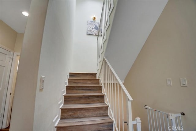 staircase with wood finished floors