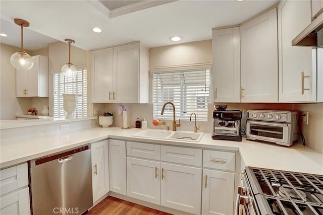 kitchen with a sink, white cabinets, stainless steel appliances, and a toaster