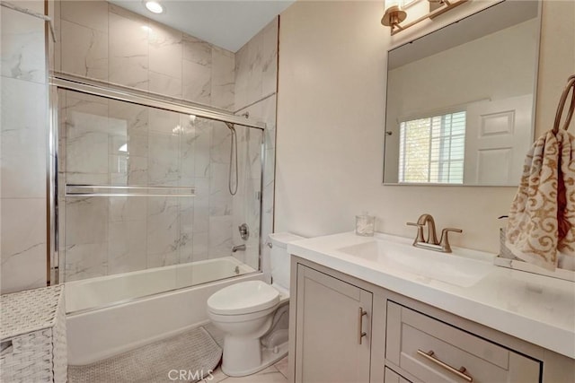 full bath featuring bath / shower combo with glass door, vanity, and toilet
