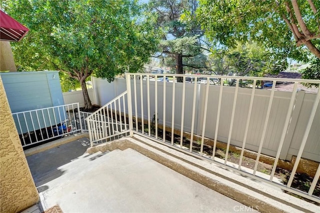view of gate featuring fence and a patio area