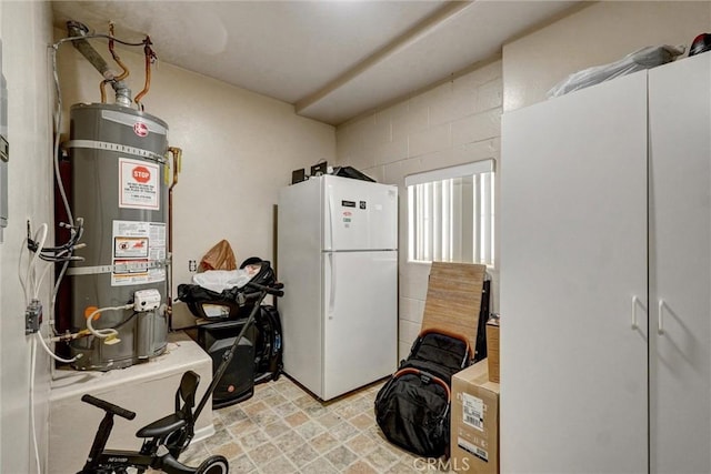 interior space with secured water heater and freestanding refrigerator