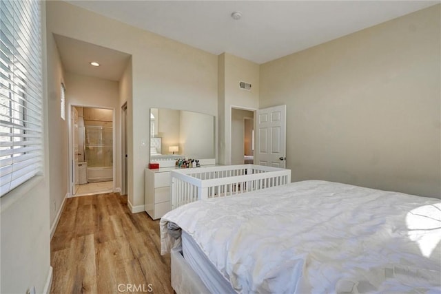 bedroom featuring baseboards, visible vents, and light wood-type flooring