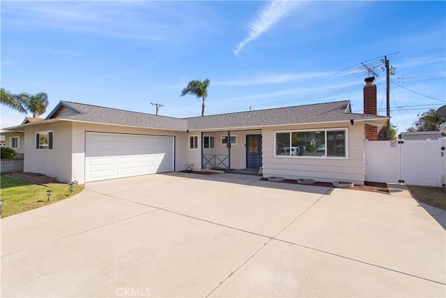 single story home featuring a chimney, a gate, driveway, a garage, and fence