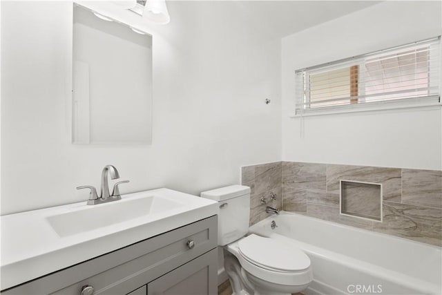 bathroom with toilet, vanity, and a washtub