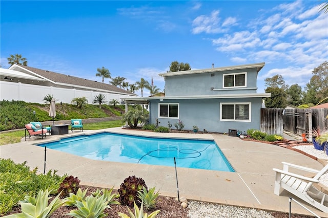view of swimming pool with a fenced in pool, a fenced backyard, and a patio area
