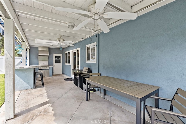 view of patio featuring outdoor dining area, ceiling fan, a grill, and area for grilling