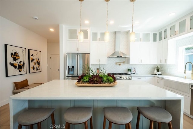 1933 Fanwood Ave, Long Beach, CA 90815 - kitchen featuring wall chimney exhaust hood, stainless steel fridge with ice dispenser, a kitchen island, tasteful backsplash, and range
