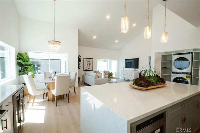 1933 Fanwood Ave, Long Beach, CA 90815 - kitchen with stacked washer and clothes dryer, high vaulted ceiling, a chandelier, beverage cooler, and open floor plan