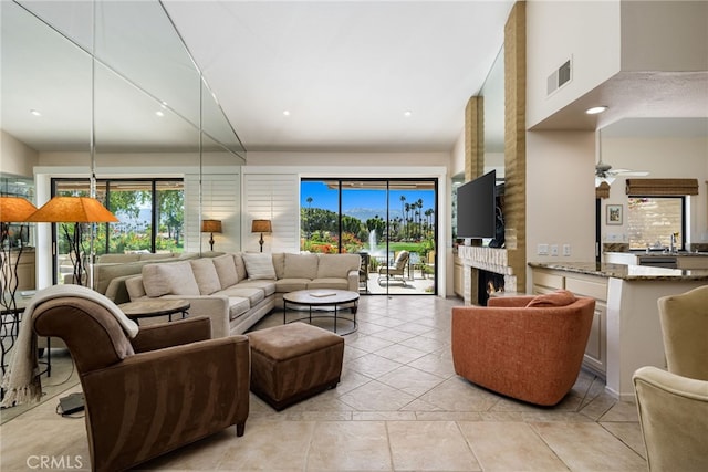 175 Bouquet Canyon Dr, Palm Desert, CA 92211 - living area with recessed lighting, a large fireplace, a high ceiling, ceiling fan, and visible vents