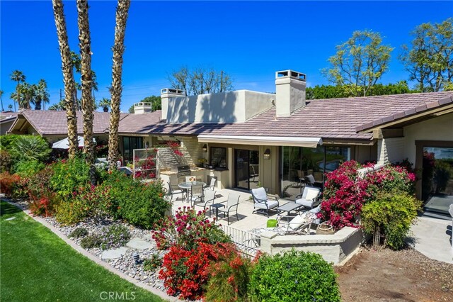 175 Bouquet Canyon Dr, Palm Desert, CA 92211 - back of house with a chimney and a patio area