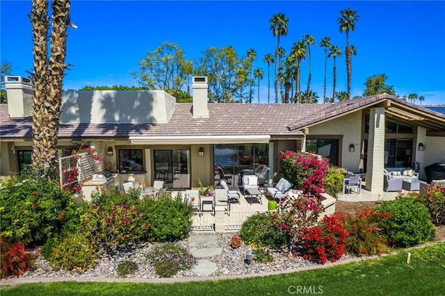 175 Bouquet Canyon Dr, Palm Desert, CA 92211 - rear view of house featuring a patio area, stucco siding, an outdoor living space, and a chimney