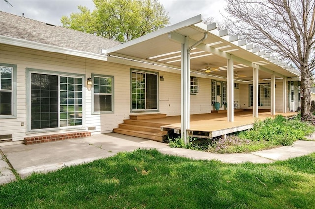 back of house with a deck, a patio area, a shingled roof, ceiling fan, and a yard