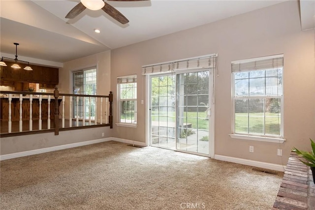 unfurnished living room featuring baseboards, ceiling fan, and carpet