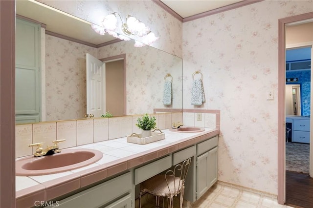 full bathroom with tile patterned floors, crown molding, double vanity, and a sink