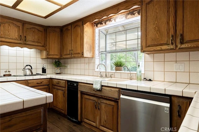 kitchen featuring dark wood-style flooring, backsplash, tile countertops, white cooktop, and dishwasher