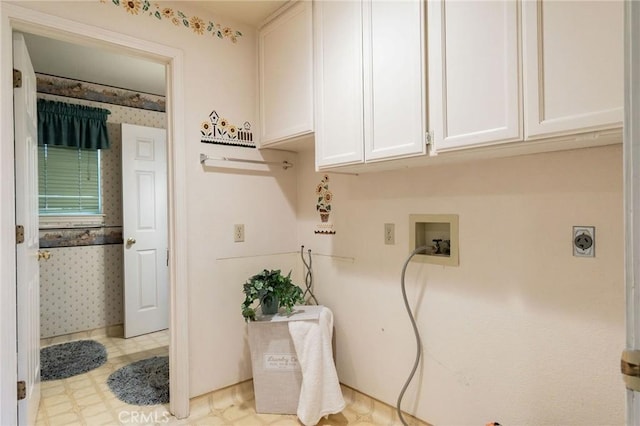 washroom featuring tile patterned floors, hookup for a washing machine, cabinet space, and baseboards