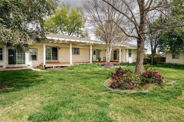 rear view of house featuring a porch and a yard