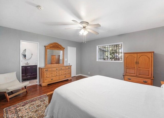 3654 7th Ave, Los Angeles, CA 90018 - bedroom featuring dark wood-style flooring, baseboards, a sink, a ceiling fan, and ensuite bathroom