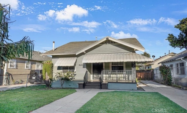 3654 7th Ave, Los Angeles, CA 90018 - bungalow-style home featuring covered porch, fence, and a front lawn