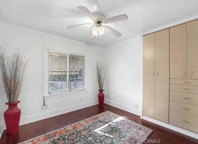 3654 7th Ave, Los Angeles, CA 90018 - bedroom with baseboards, dark wood-style flooring, and a ceiling fan