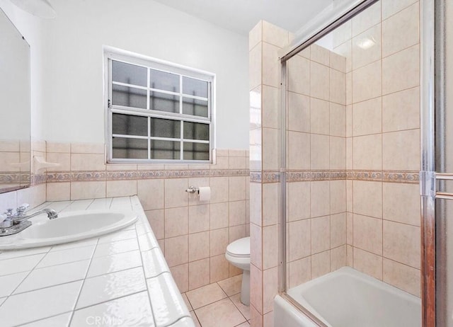 3654 7th Ave, Los Angeles, CA 90018 - bathroom with tile walls, toilet, bath / shower combo with glass door, tile patterned floors, and a sink