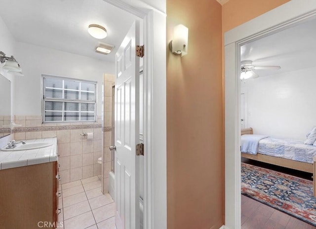 3654 7th Ave, Los Angeles, CA 90018 - ensuite bathroom featuring tile walls, ensuite bathroom, ceiling fan, vanity, and tile patterned flooring