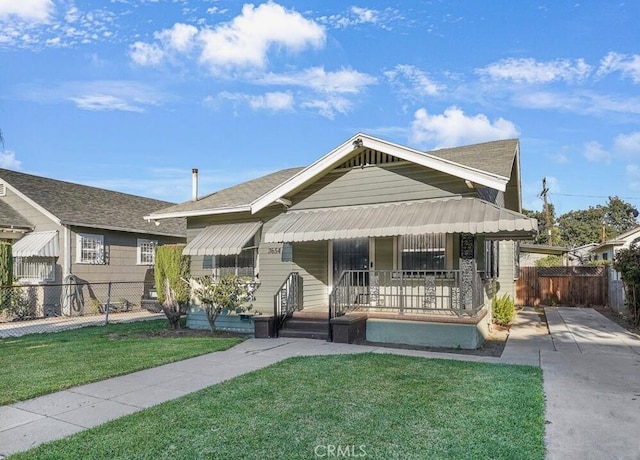 3654 7th Ave, Los Angeles, CA 90018 - bungalow-style house featuring a porch, fence, and a front lawn