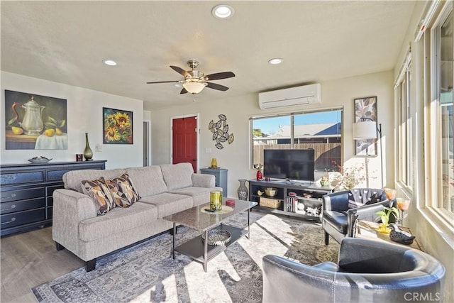 living room featuring ceiling fan, wood finished floors, recessed lighting, and a wall unit AC