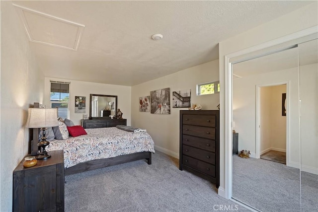 carpeted bedroom featuring baseboards and multiple windows