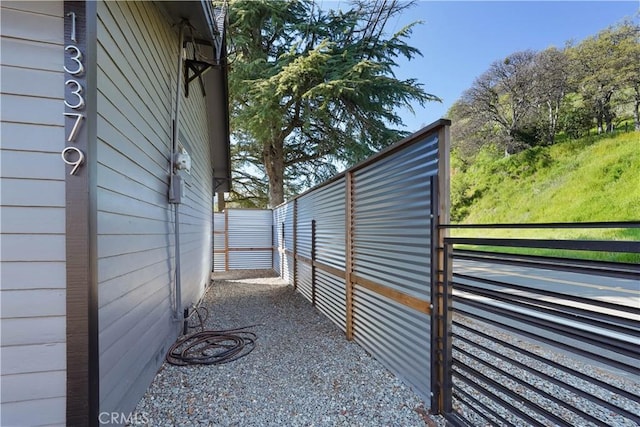 view of side of home featuring fence