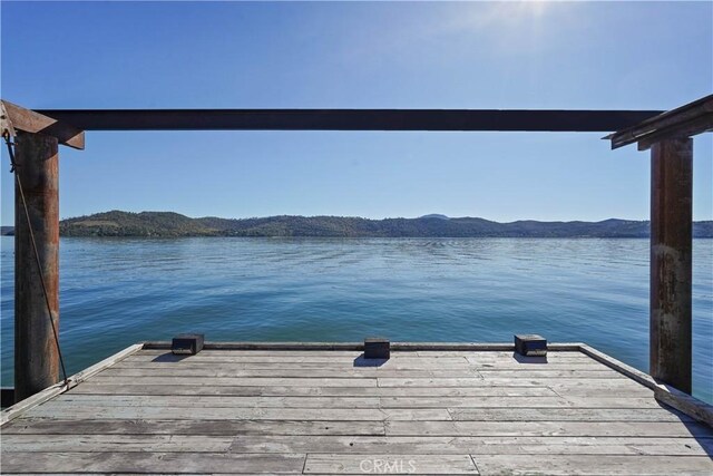 view of dock featuring a water and mountain view