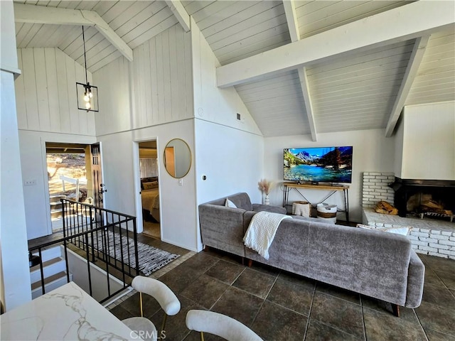 living room with high vaulted ceiling, beamed ceiling, a brick fireplace, and wood ceiling