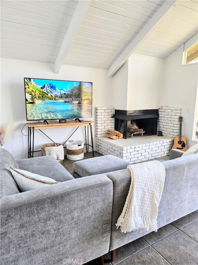 living area with dark tile patterned floors, wooden ceiling, and lofted ceiling with beams