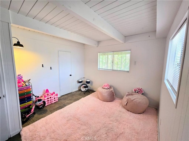 bedroom with beam ceiling and wood ceiling